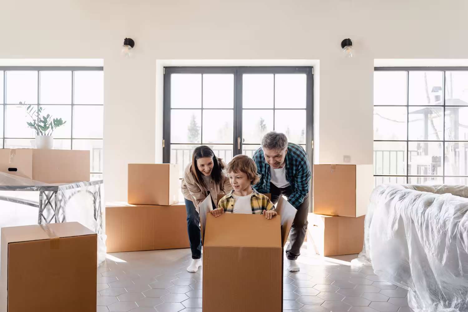 Parents happily moving out with a kid